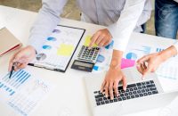 Business accountant or banker, business partner calculate and an Business accountant or banker, business partner calculate and analysis with stock financial indices and financial costs wisely and carefully, investment and finance concept.