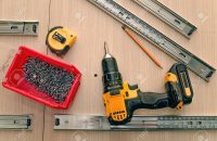 Assembling of furniture closeup Assembling furniture from chipboard, using a cordless screwdriver, close up.